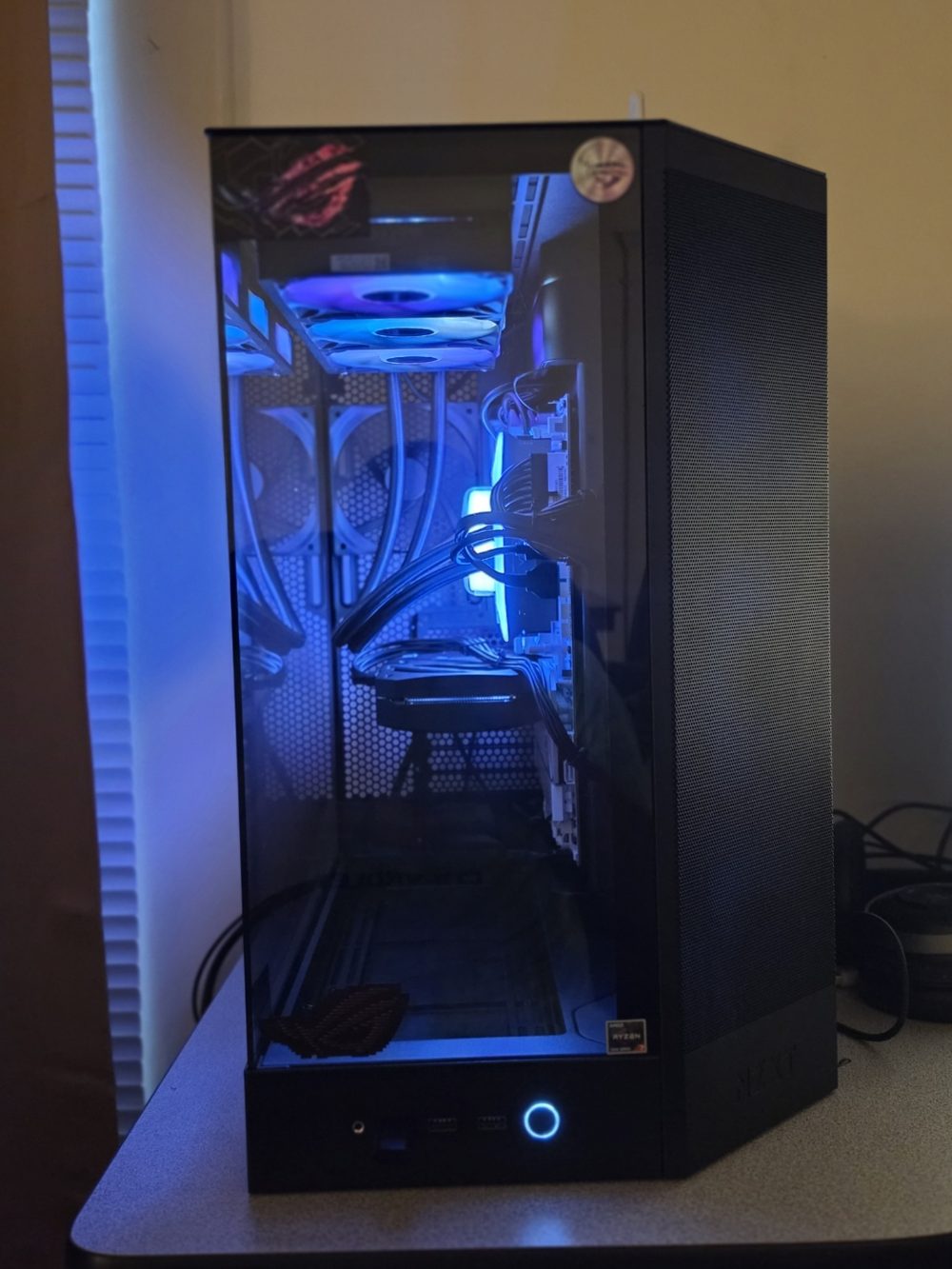Custom gaming PC with lit RGB fans seen through a tempered glass case