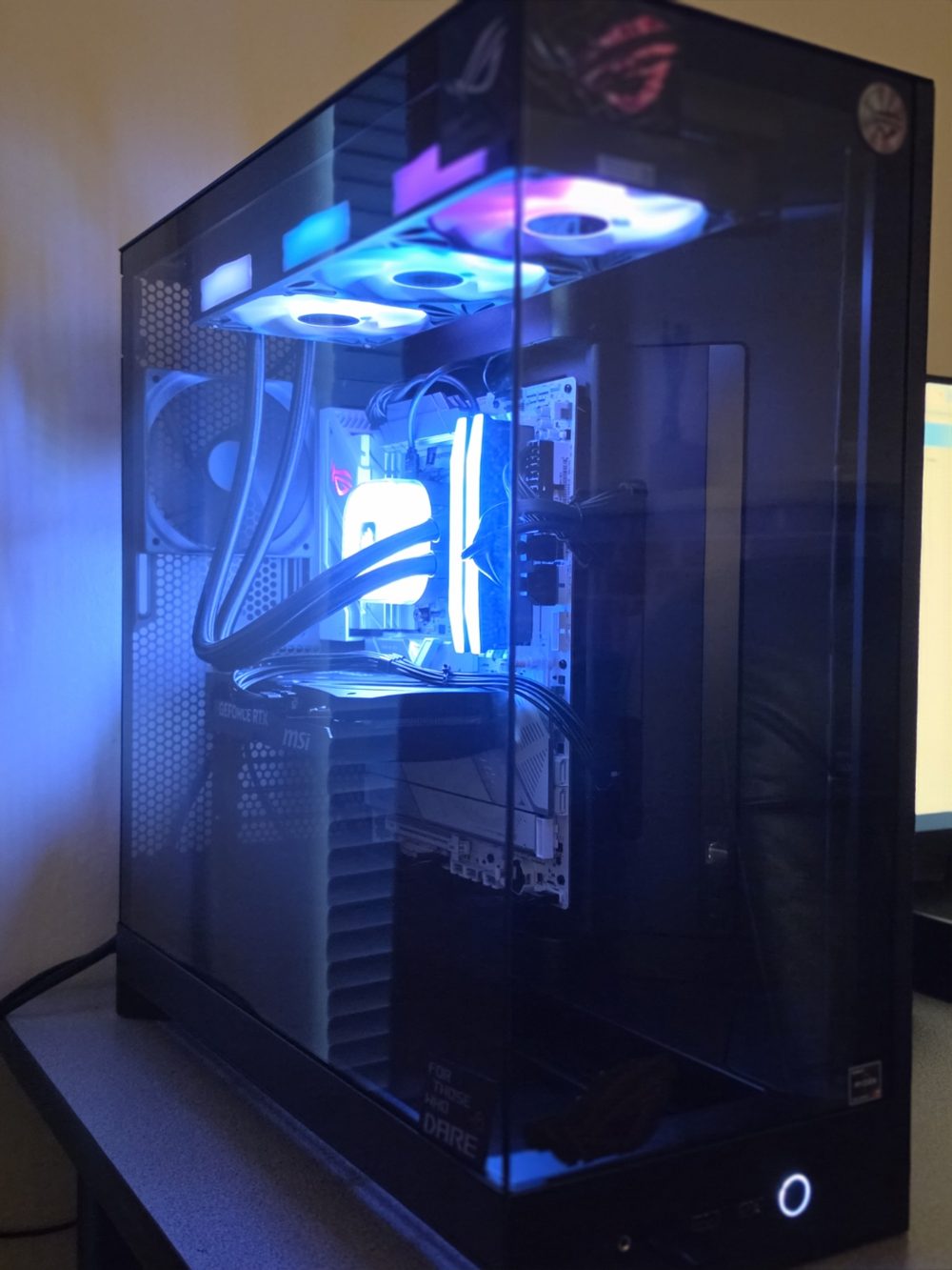 Finished custom gaming PC with glass side panel and blue RGB lighting